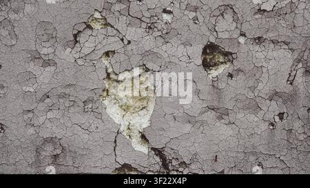 Cracked plaster texture revealing foam insulation on a damaged wall Stock Photo