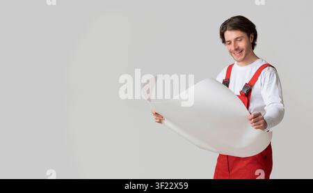 Repairing Worker Checking Blueprint, Holding Project Plan In Hands And Smiling Stock Photo