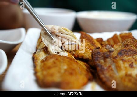 Korean style assorted grilled fish platter and side dishes on restaurant table close up Stock Photo