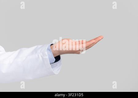 Male doctor's hand ponting or holding virtual object on open palm Stock Photo