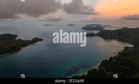 Colorful bright clouds during sunrise over the sea. Seychelles, Mahe. Stock Photo