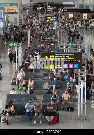 Malaga airport, Andalusia, Spain. 11th July 2026. Travellers crowd the departure lounge at Malaga airport in Spain. Stock Photo