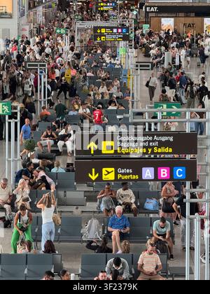 Malaga airport, Andalusia, Spain. 11th July 2026. Travellers crowd the departure lounge at Malaga airport in Spain. Stock Photo