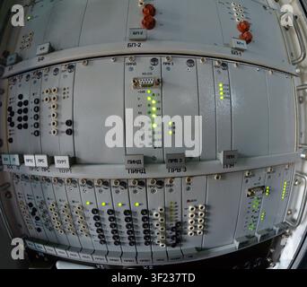 Industrial electronic equipment server rack with indicator lights and cyrillic text markings. Stock Photo