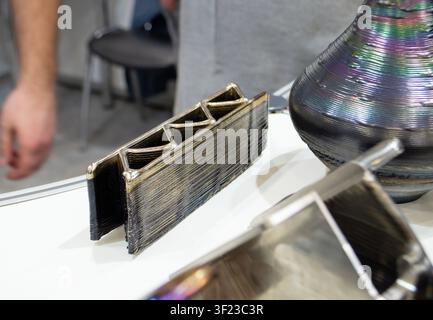 3D printed metal part. Metal detail printed on 3D printer. Created using additive manufacturing from melted metal thread. Additive new modern manufacturing. Object printed on 3D printer from metal. Stock Photo
