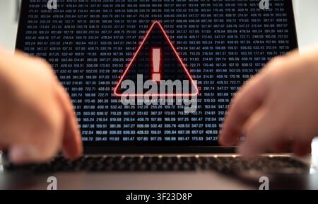 Warning sgin on a laptop screen, computer crime, system hacked or virus detected. Warning sin on a laptop screen, computer crime, system hacked or vir Stock Photo