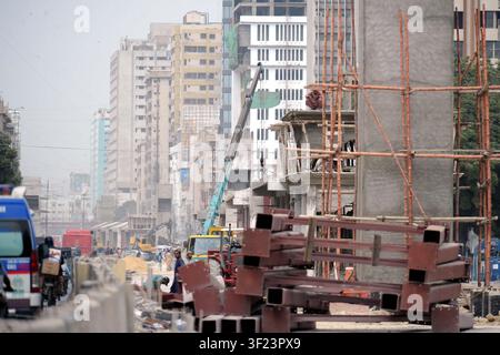 Construction on new development projects is progressing swiftly under the local government department's supervision at M.A. Jinnah Road in Karachi. The site is bustling with industrial activity, featuring cranes and excavators as workers engage in building tasks. This initiative is part of the city's broader urban expansion efforts, aimed at enhancing infrastructure amidst a densely populated backdrop. The development is significant for addressing urban congestion and improving local facilities. Such projects reflect ongoing governmental commitments to advancin Stock Photo