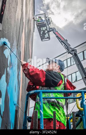 Street artists working on a commercial mural Stock Photo
