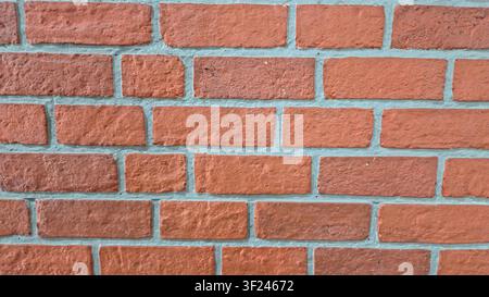 Full Frame Background of an Orange Red Brick Wall Texture with Light Gray Mortar Joints Stock Photo
