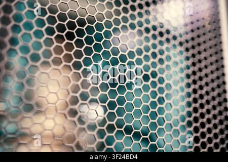 A close-up photograph of a hexagon-shaped wire mesh pattern, showcasing detailed construction, geometric design, metallic texture, and industrial appe Stock Photo