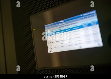 A digital security alarm panel displaying alert statuses and notifications, used for monitoring and managing security systems in commercial or residen Stock Photo