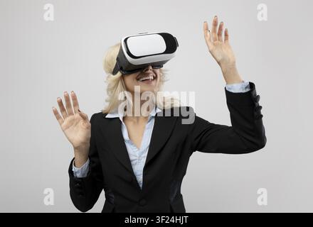 Happy Young Caucasian Woman Wearing Vr Headset Experiencing Virtual Reality, Office Setting Stock Photo