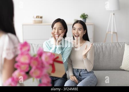 Happy Asian Women Surprised With Gift Box At Home, Excited Celebration Moment Stock Photo