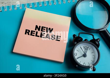 Concept of new release write on sticky notes isolated on Wooden Table. Stock Photo