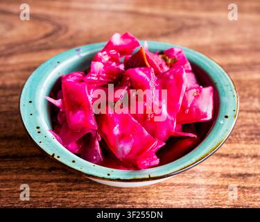 Traditional Turkish Lahana Turşusu, pickled red cabbage with beetroot in turquoise bowl. Stock Photo
