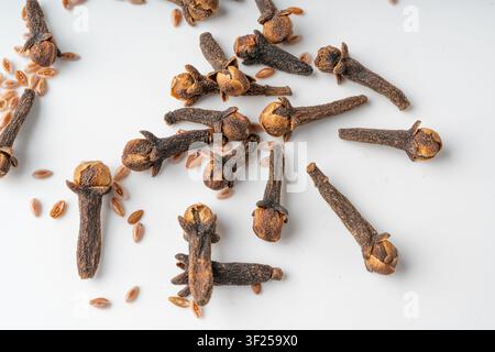 Clove spice isolated. Macro dry carnation spicy buds, natural Indian clove condiment, aromatic brown sticks close up on white background top view, aro Stock Photo