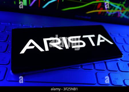 Arista Networks Cloud Networking and Data Center Technology Company Logo on Smartphone With Stock Market Performance Chart Stock Photo