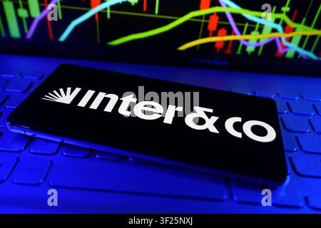 Intel Logo Displayed On Smartphone In Front Of Computer Showing Stock Market Performance Chart Stock Photo