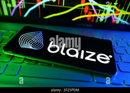 Blaize Logo Displayed On Smartphone In Front Of Computer Showing Stock Market Performance Chart Stock Photo