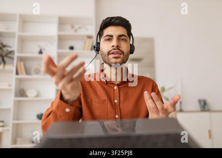 Young Caucasian Man Wearing Headset Speaking In Office, Business Concept Stock Photo