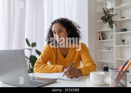 Focused Young Black Woman Working On Laptop In Home Office, Business Concept Stock Photo