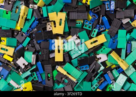 Circuit board jumper caps plastic computer components scattered loosely. Stock Photo