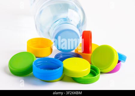 Plastic bottle colored screw caps for recycle waste on white background, container water lid. Stock Photo