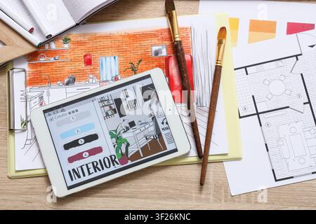 Interior design planning with a digital tablet displaying color palettes and a hand-drawn sketch of a kitchen Stock Photo