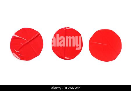 Three red round adhesive tape pieces with wrinkled texture, isolated on a clean white background Stock Photo