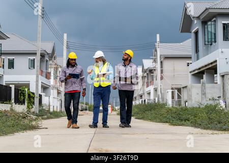 Engineers discussed preparation for installing small solar panels in residential village construction areas for sustainable energy projects and improv Stock Photo
