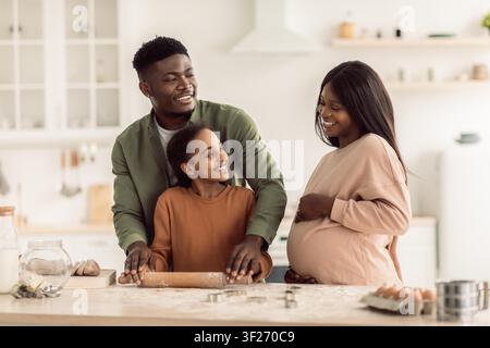Happy African American Family Baking Together In Kitchen, Expecting New Baby, Family Concept Stock Photo