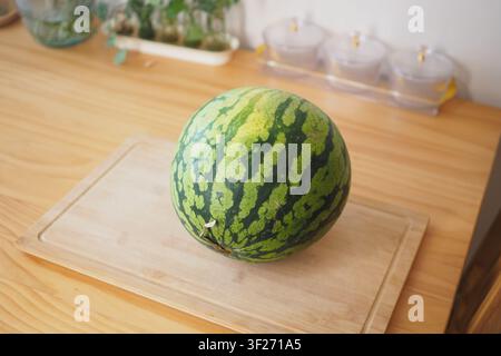 Watermelon on wooden board in kitchen Stock Photo