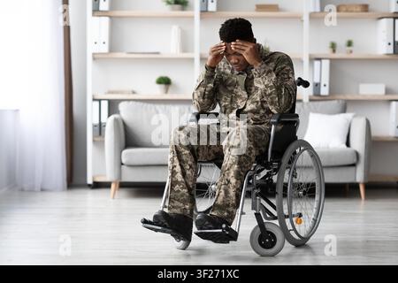 Concerned Young Black Man In Wheelchair Experiencing Challenging Emotions, Home Setting Stock Photo
