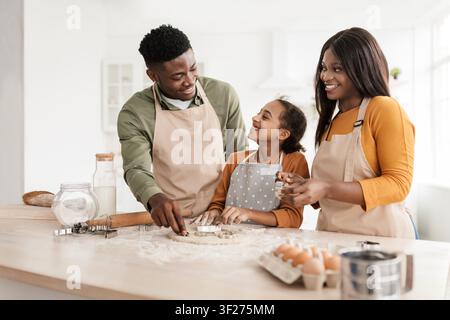 Happy African American Family Baking Together In Modern Kitchen, Smiling And Creating Fun Moments Stock Photo