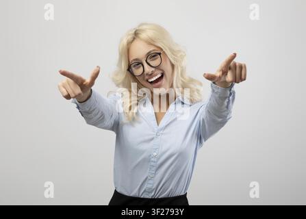 Happy Young Caucasian Woman Smiling And Pointing, Business Concept Stock Photo