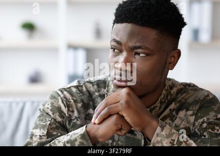 Thoughtful Black Male Soldier Pondering At Office, Weight Loss Concept Stock Photo