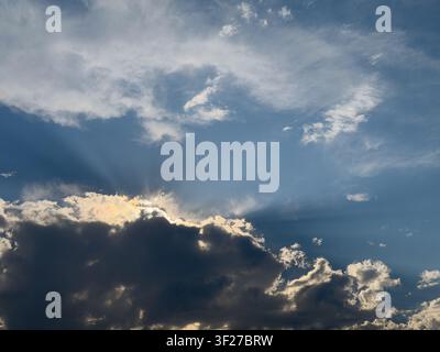 Sun rays breaking through dramatic clouds above the Pacific Northwest sky. Stock Photo