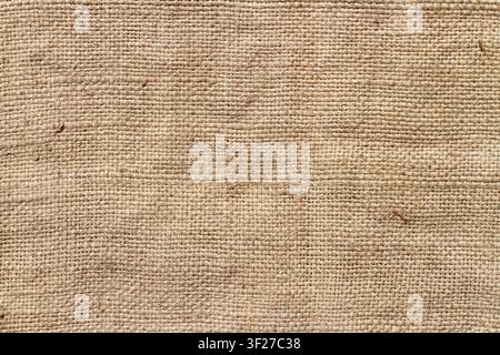 Coarse natural burlap fabric. The texture of natural burlap. Stock Photo