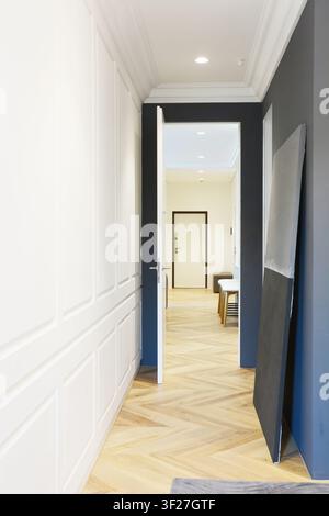 Modern corridor interior in cozy house. View from the corridor on entrace door. Stock Photo