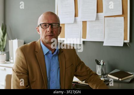 Portrait of Middle Aged Man Sitting in Military Hospital Office Stock Photo