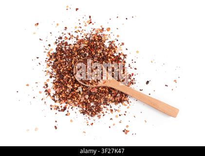 Chili and salt seasoning pile in spoon isolated, red chilli pepper spice powder, dry crushed hot pepper flakes with seeds on white background Stock Photo
