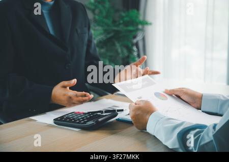 Financial consultant handing business report to client during office meeting, representing accounting review, investment planning, budget analysis and Stock Photo