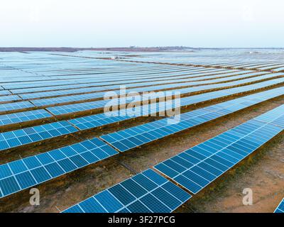 Massive Solar Panel Farm with Utility Scale Photovoltaic Arrays Captured by Drone Stock Photo