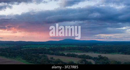 Aerial panorama view of a dramatic colorful sunset sky over farmland and distant mountain at Newstead in Centarl Victoria, Australia Stock Photo