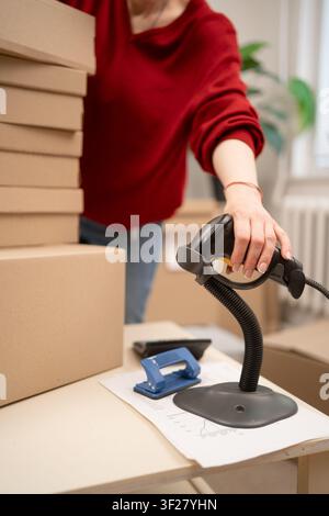 barcode scanner scanning box at retail shop. service counter parcel processing Stock Photo
