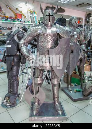 Zaporizhzhia museum shop features a full size knight in shining armor with a shield and axe.  Zaporizhzhia, Ukraine - June 24, 2017 Stock Photo