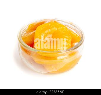 Canned Peaches in Bowl Isolated, Apricot Halves in Syrup, Yellow Fruit Dessert, Tinned Nectarine Compote, Orange Peeled Peache Slices on White Backgro Stock Photo