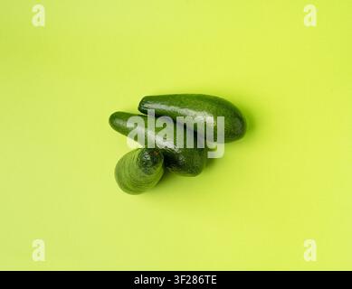 Avocado Isolated, Whole Avokado Set, Three Green Avocados Pile, Fresh Alligator Pear, Guacamole Ingredient, Long Avocado Fruit on Green Background Stock Photo
