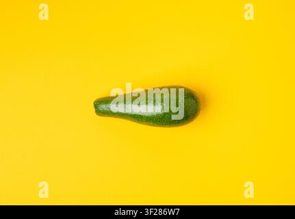 Avocado Isolated, Whole Avokado, One Green Avocado, Single Fresh Alligator Pear, Guacamole Ingredient, Long Avocados Fruit on Yellow Background Stock Photo