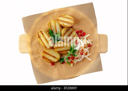 Grilled potatoes with onions and pomegranate seeds Stock Photo